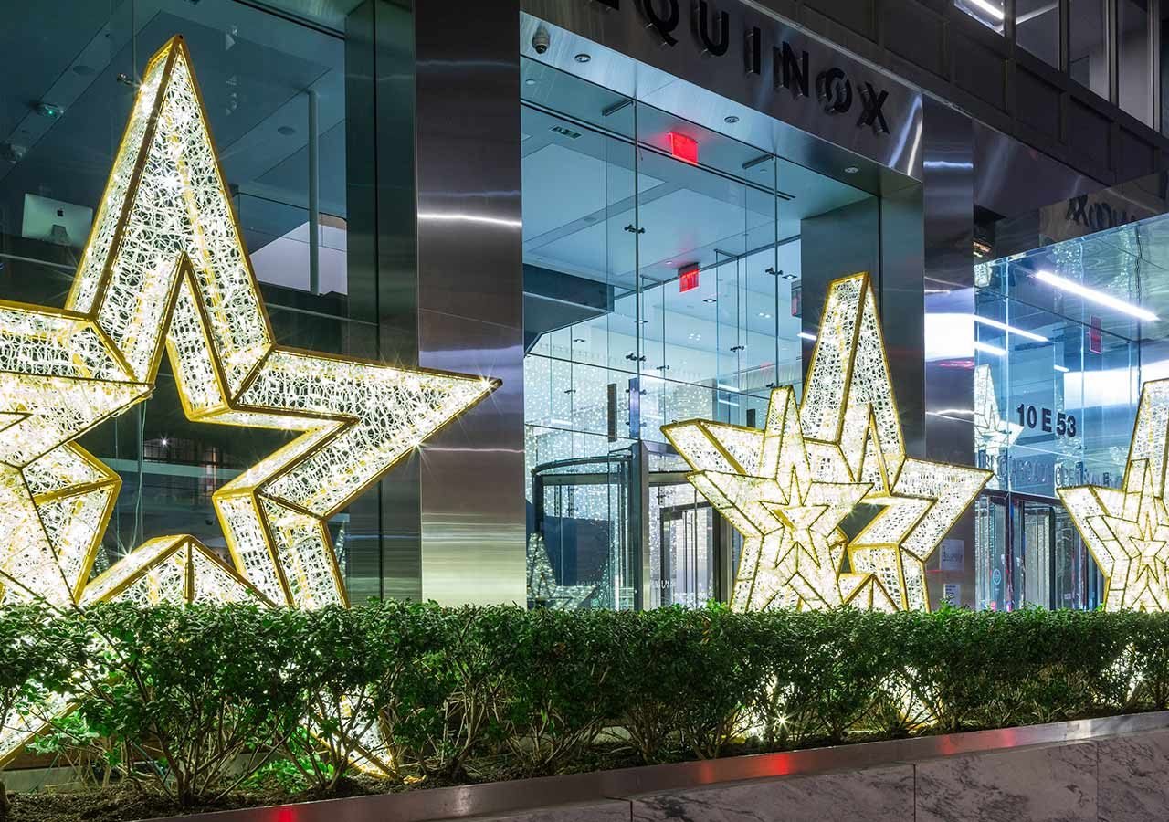 Three large LED lit stars in front of a NYC building at 10 E 53rd Street.