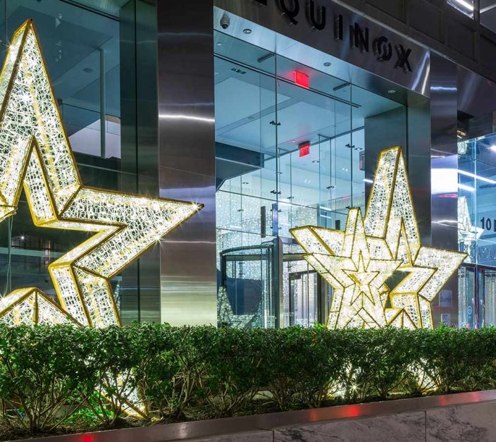 Three large LED lit stars in front of a NYC building at 10 E 53rd Street.
