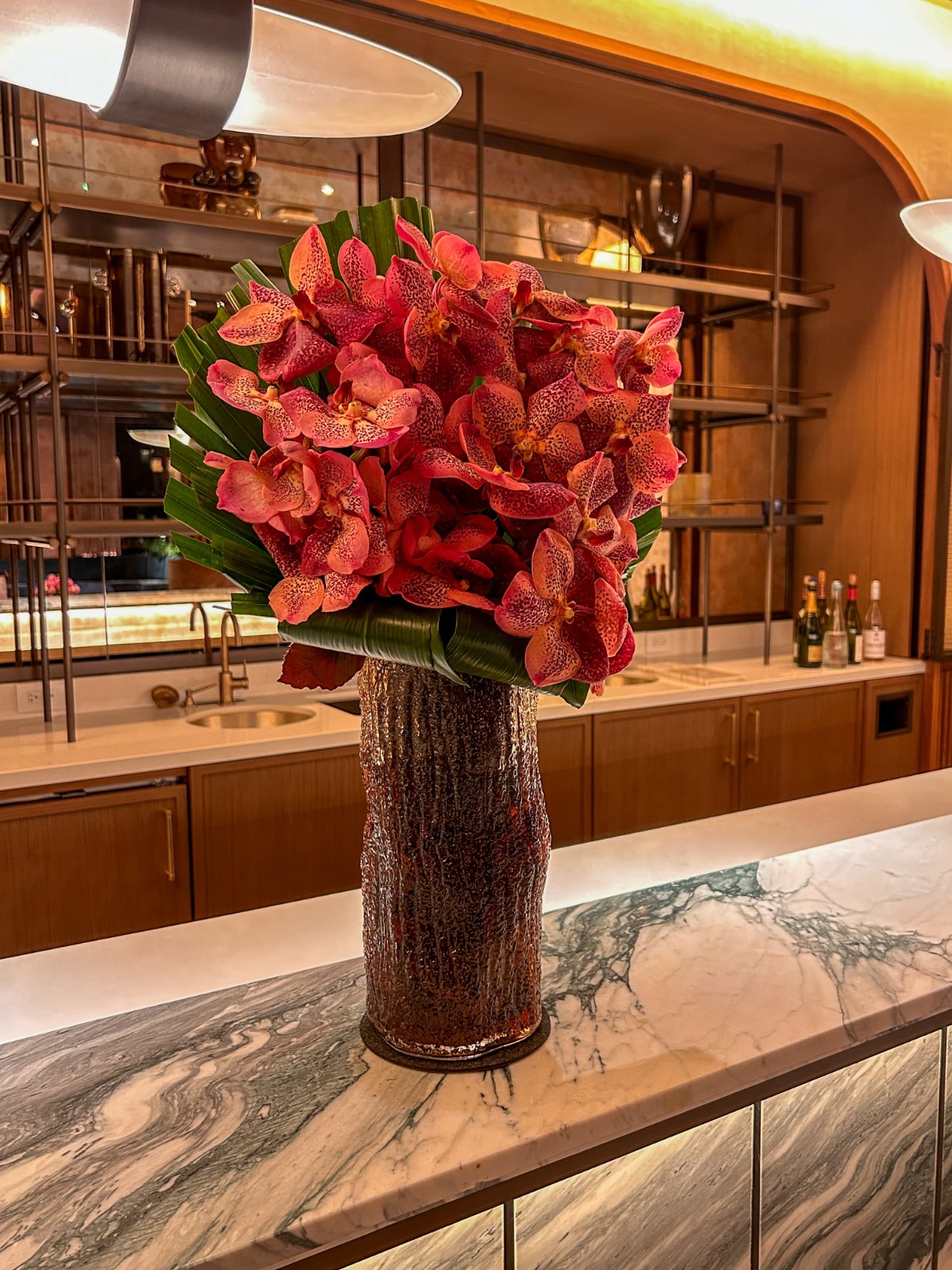 orange-floral-arrangement-at-party-bar