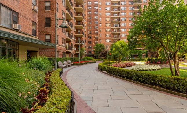 summer commercial landscaping with lush green lawns flower beds and manicured hedges at NYC residential property