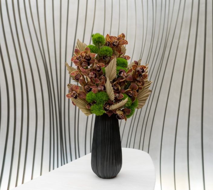 dark burgundy orchid arrangement for fall seasonal decor in commercial office space