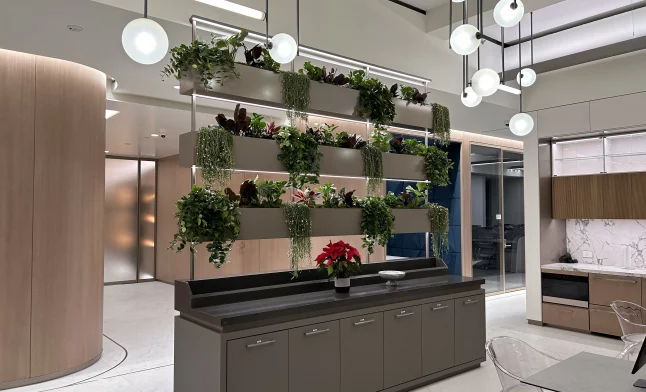 interior living plant wall with cascading greenery on tiered shelves in a modern corporate lobby