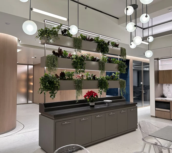 interior living plant wall with cascading greenery on tiered shelves in a modern corporate lobby